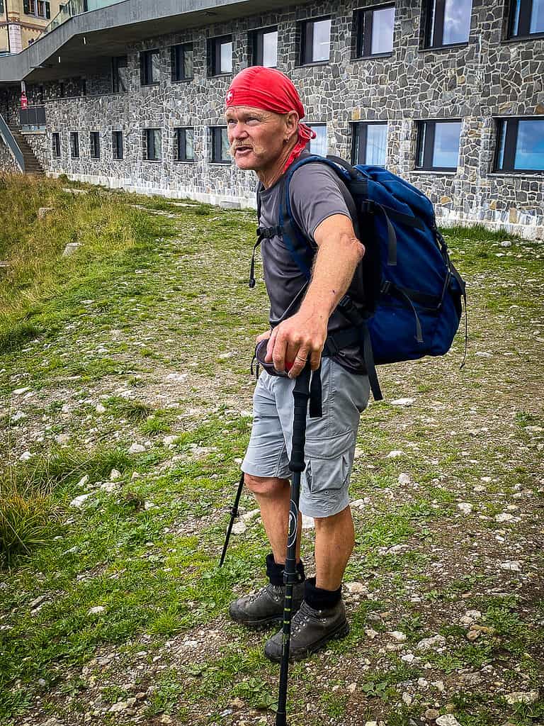 20220906 Anniversary 2464 LRE Web Hiker with trekking poles completing the Mt. Pilatus trail from Alpnachstad.