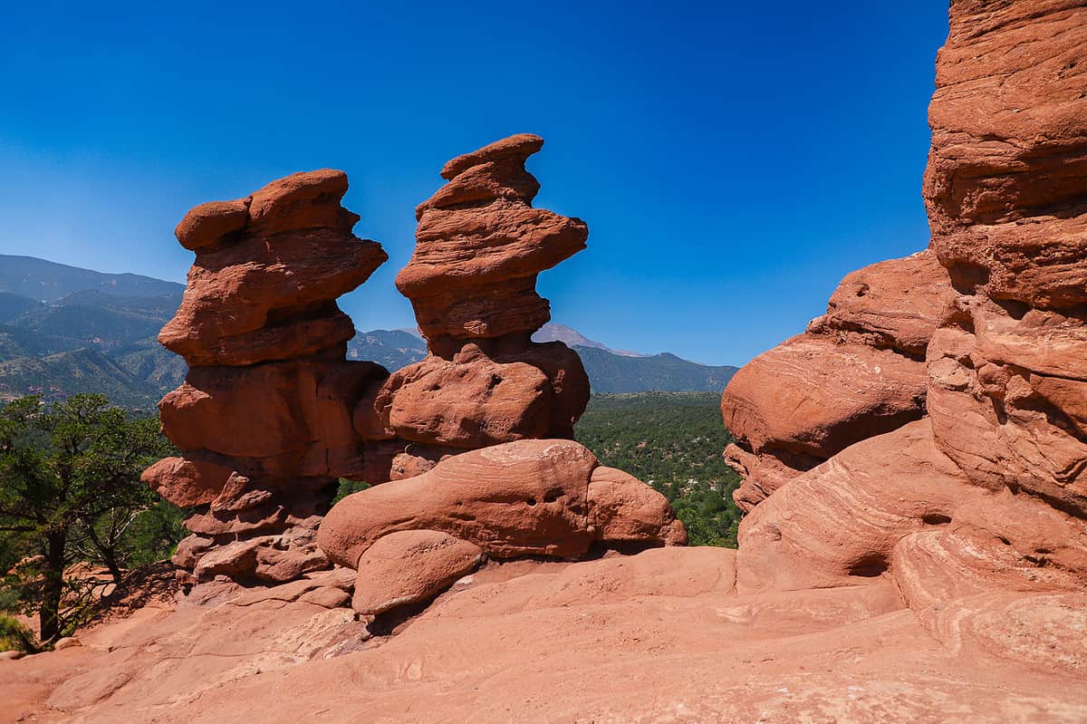 Dramatic red rock formations rising against a bright blue sky, highlighting outdoor family adventures in the Garden of the Gods in Colorado Springs.