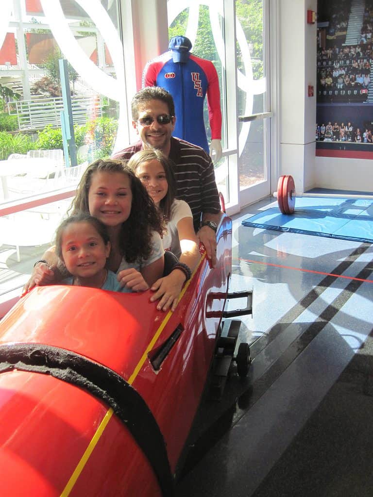 Chris and the girls posing in a bobsled at the Olympic Training Center in Colorado Springs