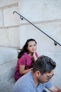 Sitting on the stairs by the triumphal arch in Vienna with teens