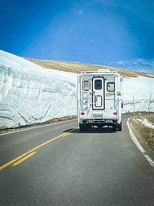 RV driving in the mountains with snow.