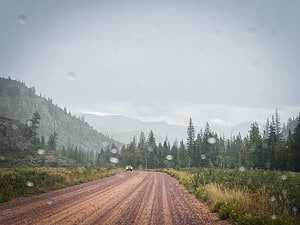 Driving in the mountains in bad weather using hour headlights.