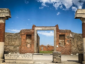 Ancient stone ruins and columns under a bright sky, perfect for a guide to things to do in pompeii.