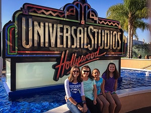 Family sitting by the Universal Studios Hollywood sign in CA