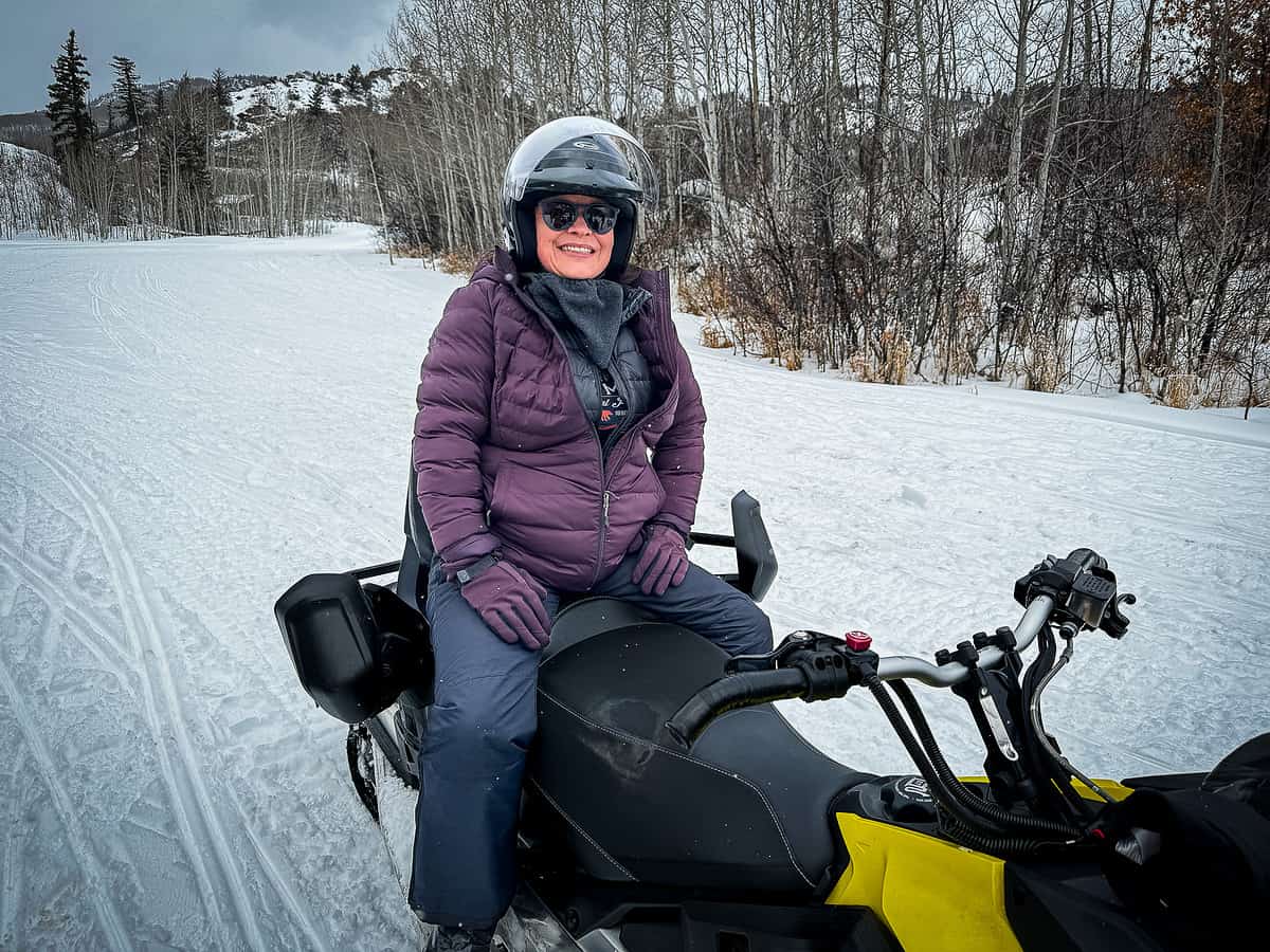 20240122 snowmobile 0216 Woman on a snowmobile in winter gear near Glenwood Springs, Colorado.