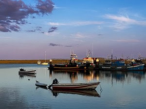 Sunset overlooking boats from Santa Luzia, Portugal in one of the instagrammable spots in the Algarve.