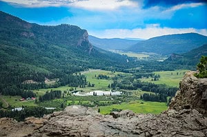 A scenic overlook with rocky terrain and a lush green valley below, highlighting adventurous things to do in Durango, Colorado.