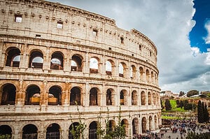 Things to do in Rome include visiting the Colosseum for your rome travel itinerary. The ancient Colosseum in Rome against a blue sky, one of the most beautiful places in Italy for photographers.