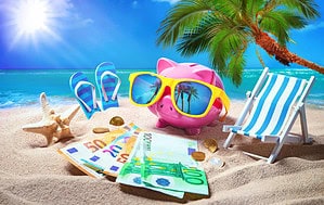 Piggy bank relaxing at the beach showing simple ways to save money on trips.