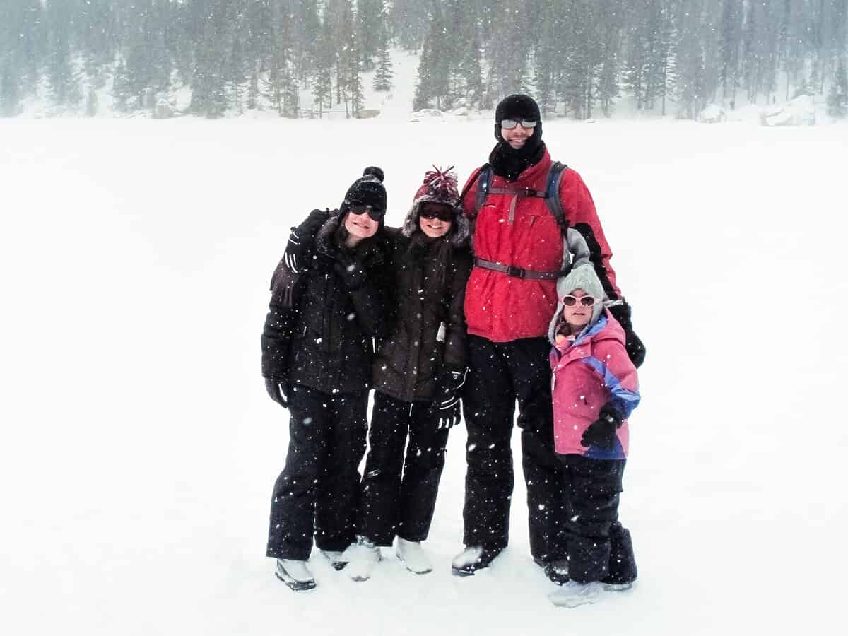 20120116 winterhiking 4986 2 Family bundled up in winter gear, standing in the snow before a winter hiking trip in Colorado.