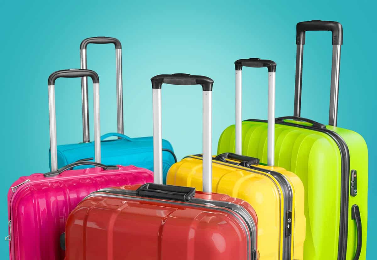 20230305 colorfulluggage Colorful hard-shell suitcases lined up against a blue background. Great resources for travel and when you plan a trip to Europe.