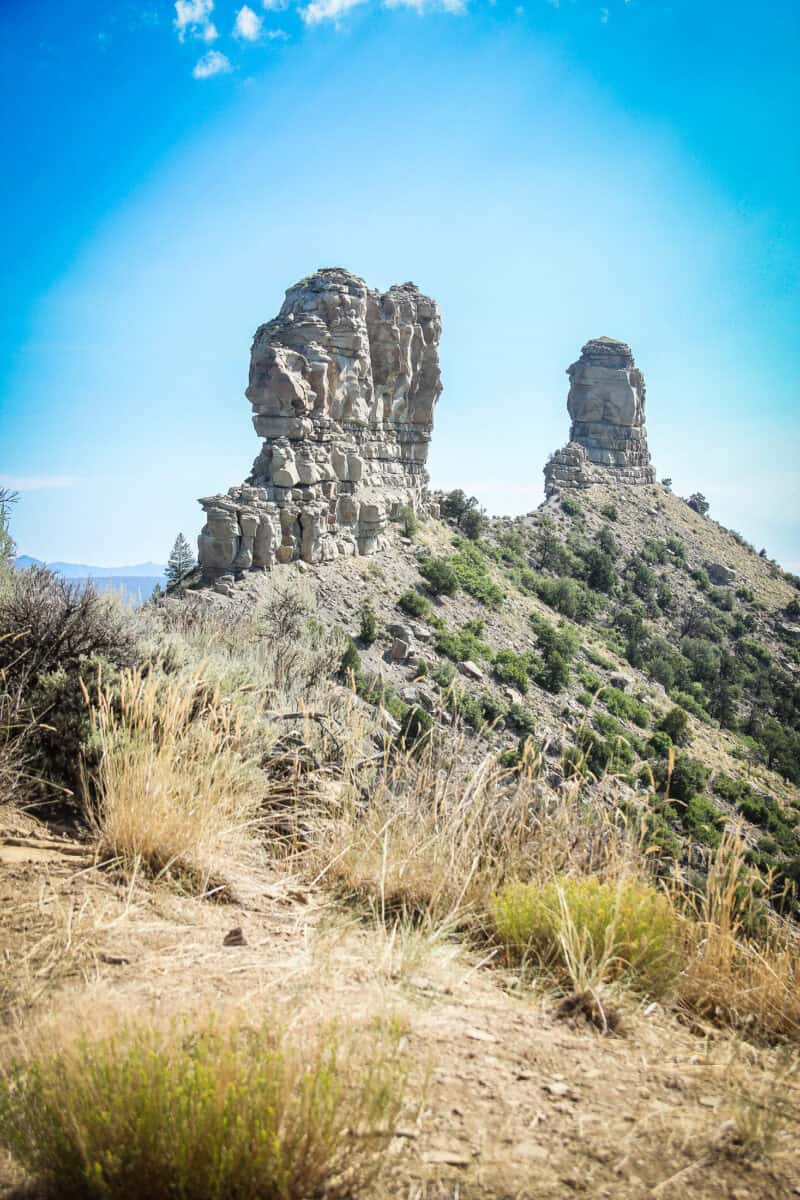 Chimney Rock and Companion Rock pinnacles rising above the ridgeline at Chimney Rock National Monument in Colorado.