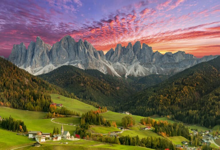 Dolomitescolorbykkwasny222 Santa Maddalena village beneath the Odle mountain range at sunset in the Dolomites, Italy.