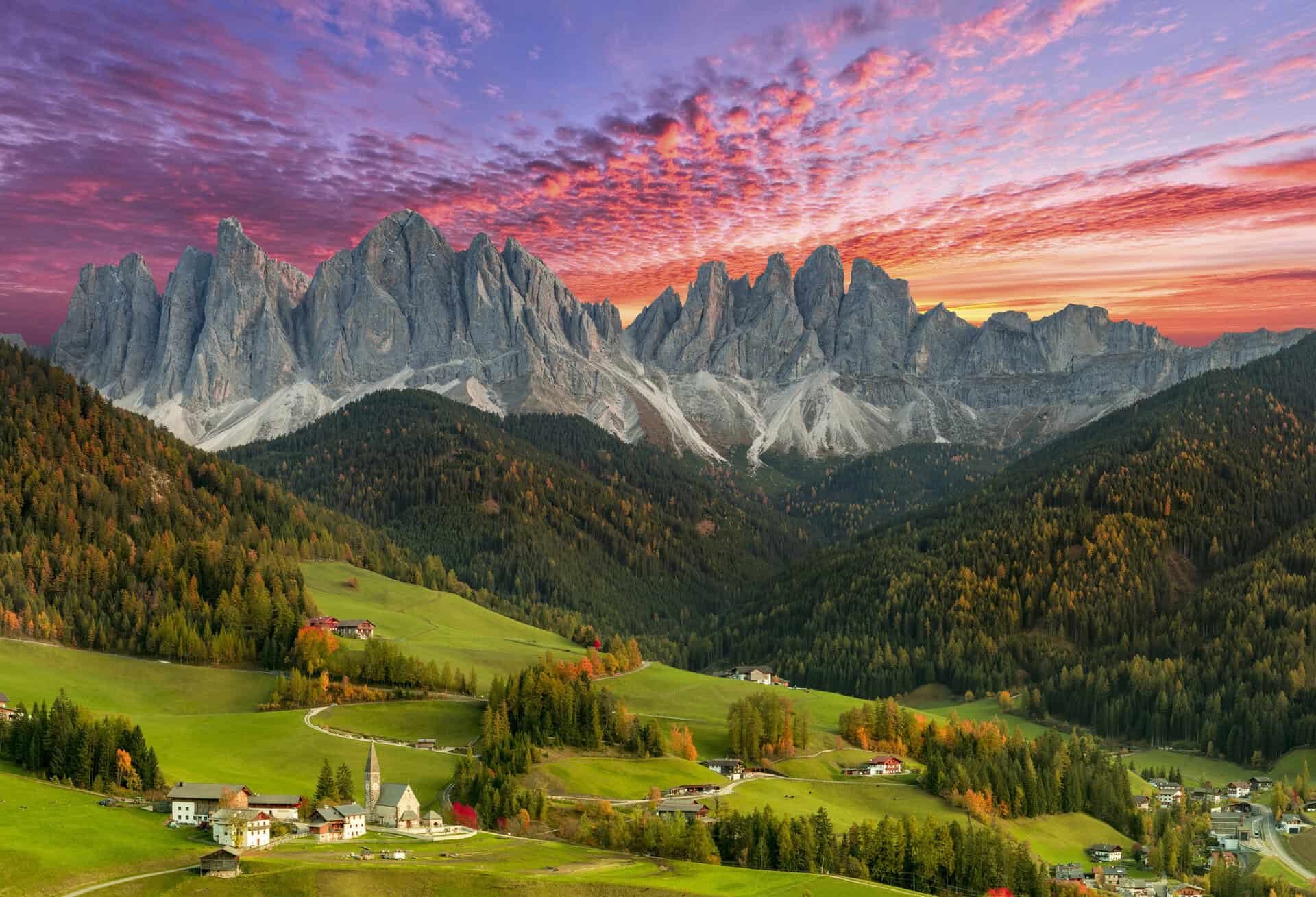 Santa Maddalena village beneath the Odle mountain range at sunset in the Dolomites, Italy.