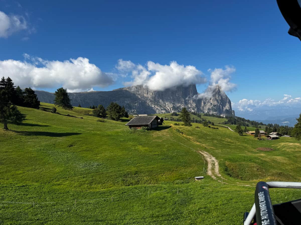View of Schlern Mountain and green meadows from the Panorama chairlift on Alpe di Siusi.